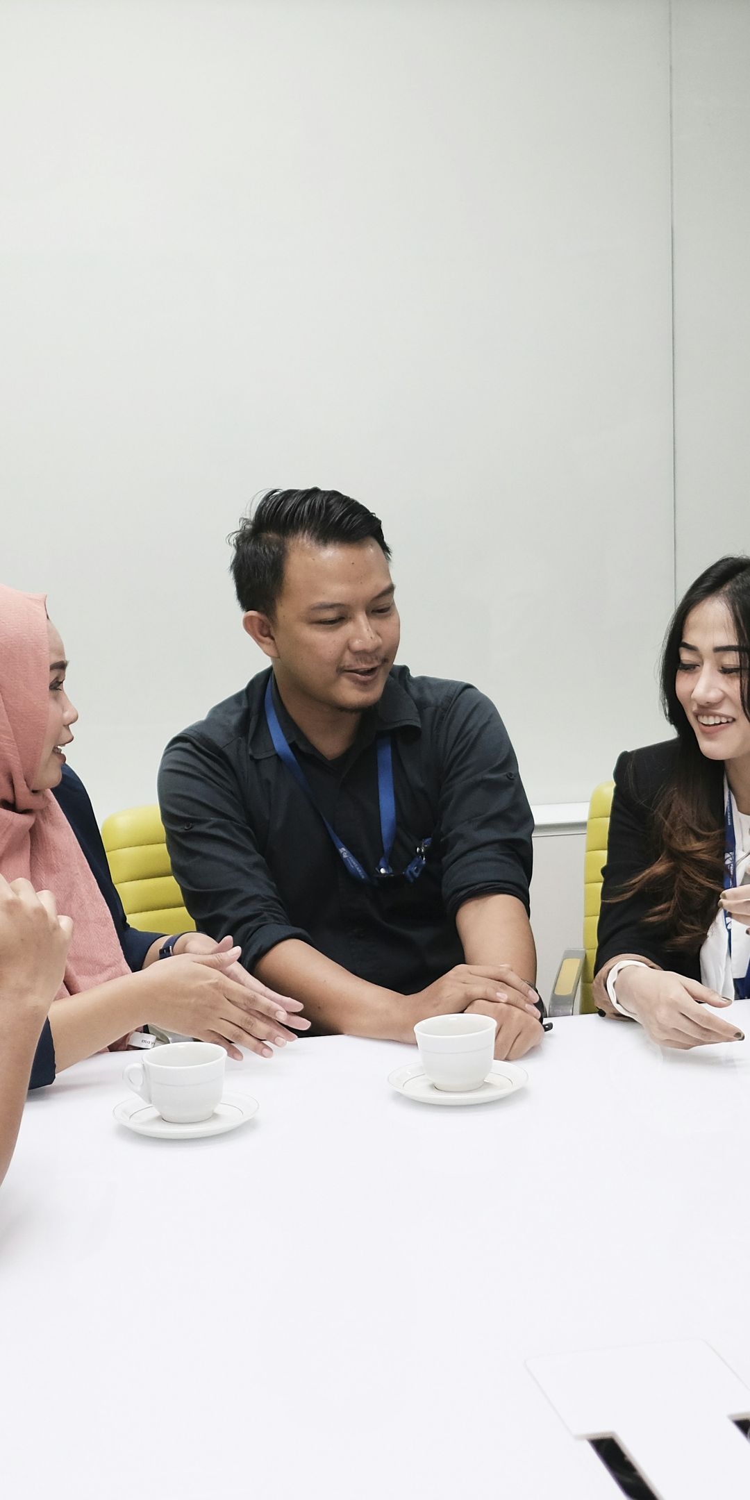 Colleagues in a discussion around a meeting table in a modern office